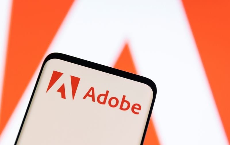Adobe raises annual revenue forecast, CFO to exit